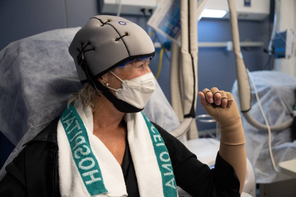 person wearing the hair cryotherapy cap